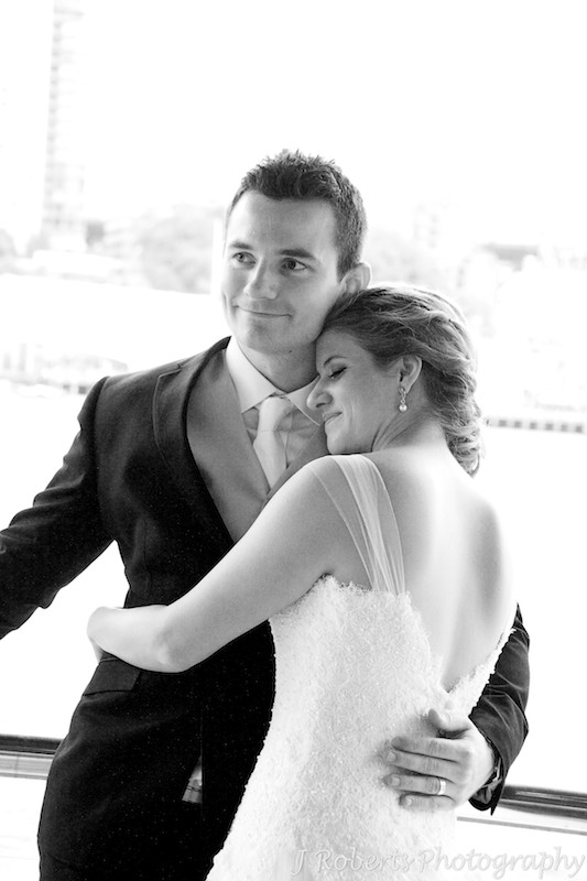 Bride snuggling into groom - wedding photography sydney